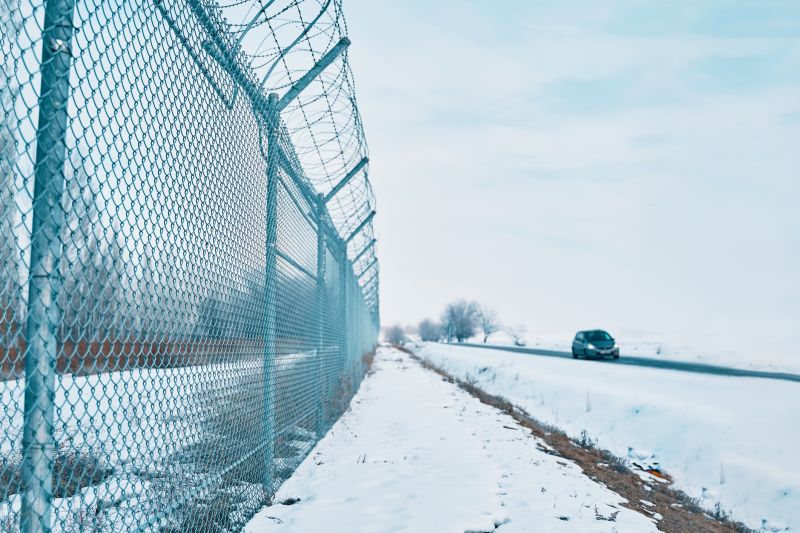 Barbed Wire Fence with Snow Cover
